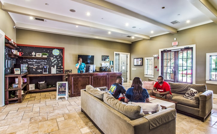the collective at lubbock cottage apartments clubhouse leasing desk and coffee bar