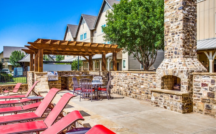 the collective at lubbock cottage apartments poolside fireplace grilling and picnic area
