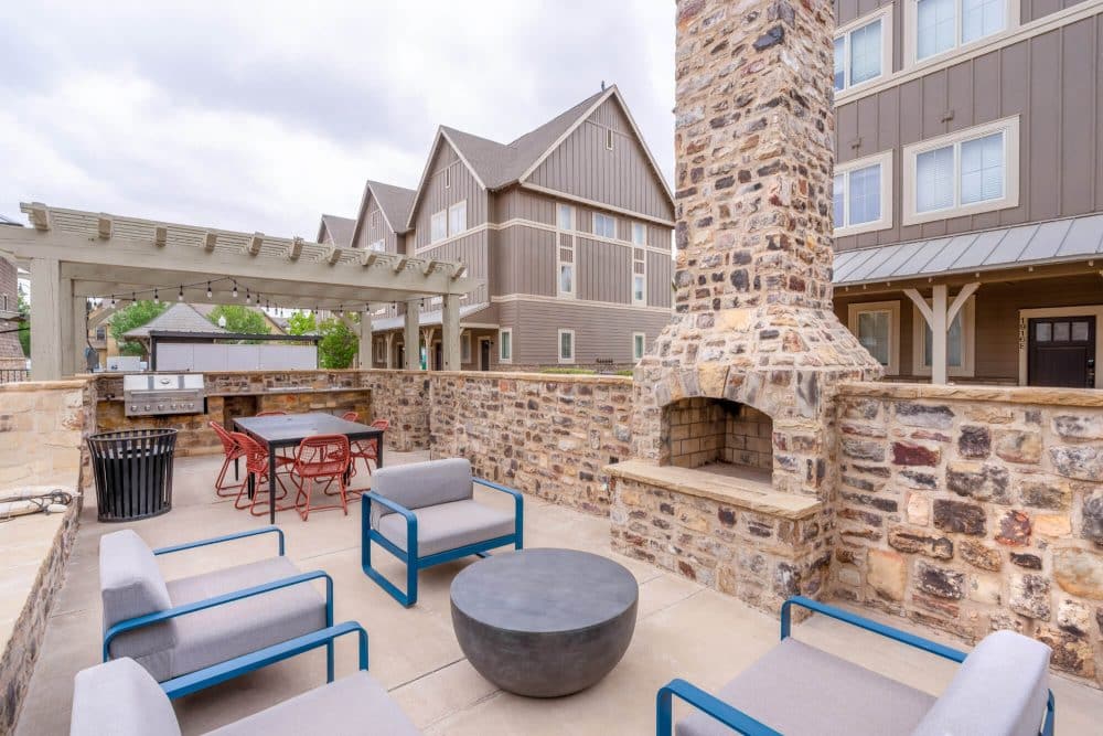 the collective at lubbock off campus cottage apartments near texas tech ttu community amenities outdoor fireplace and lounge seating